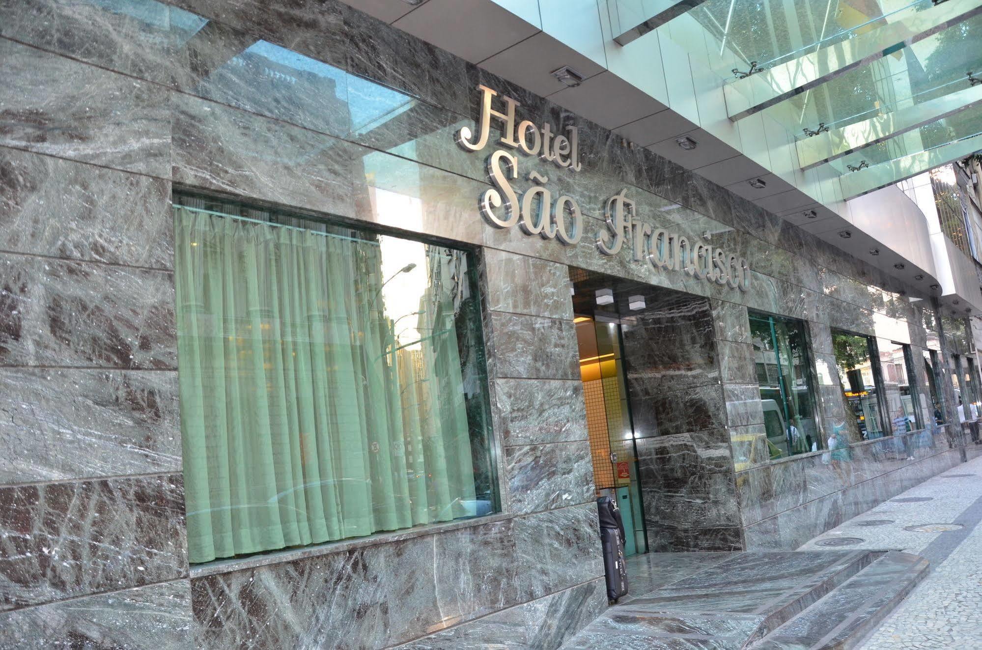 Hotel Atlantico Tower Rio de Janeiro Dış mekan fotoğraf The photo shows the exterior of a hotel named "Hotel São Francisco." The facade is made of marble, giving it an elegant appearance, and large glass windows are visible, likely allowing natural light to enter the interior. There are light green curtai